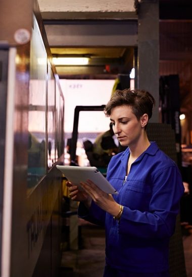 Female engineer inspecting equipment in a steel factory.